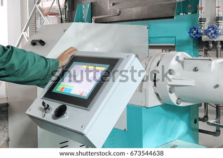 pressing important technology button at control panel in plant