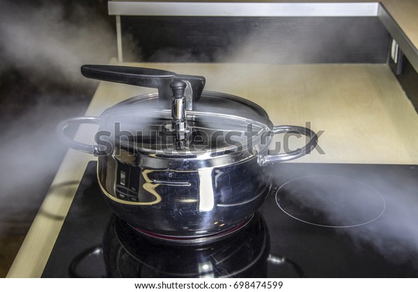 Pressure cooker releasing hot\
steam