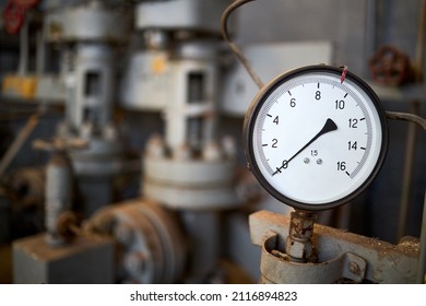 Pressure Gauge Or Manometer Shows Zero Closeup With Crane Or Valve Cover Out Of Focus Background With Copyspace. Example Of Chemical Plant Retro Style Equipment.