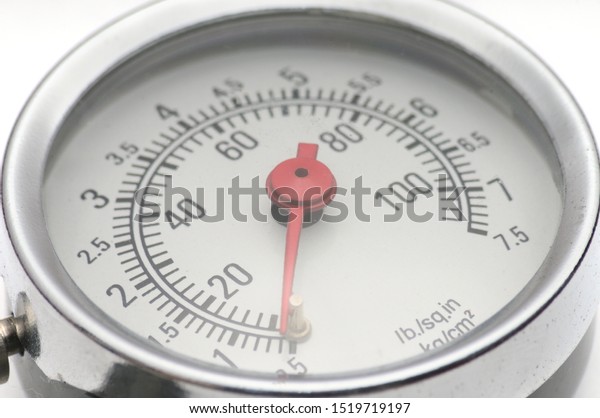 Pressure gauge for measuring\
air pressure in automobile tires close-up on an isolated white\
background