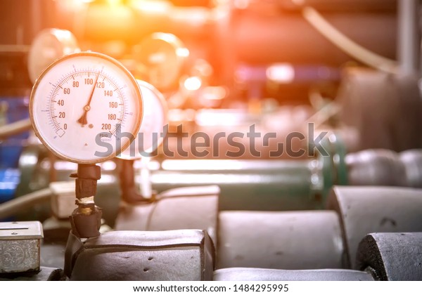 Pressure gauge on the cylinder of the\
industrial refrigeration. Pressure Gauge of Steel Tank Inside the\
refrigerant tank in the building at bangkok ,\
Thailand.
