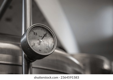 Pressure gauge on the pipe of craft brewing equipment in a brewery - Powered by Shutterstock