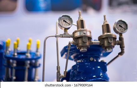 Pressure Gauge Psi Meter In Pipe And Valves Of Water System Industrial Focus Left Closeup White Light Defocus Blur Background.