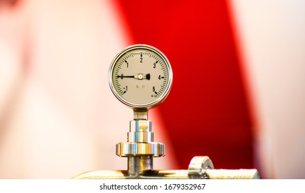 Pressure Gauge Psi Meter In Pipe And Valves Of Water System Industrial Focus Left Closeup White Light Defocus Blur Background.