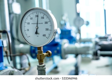 Pressure Gauge Psi Meter In Pipe And Valves Of Water System Industrial Focus Left Closeup White Light Defocus Blur Background