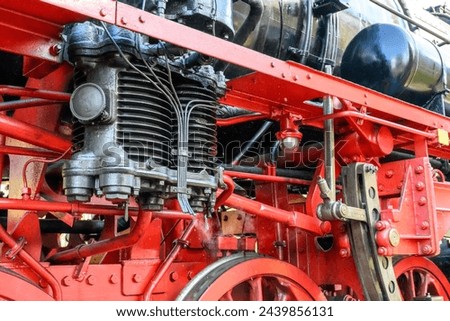 Pressure pipes of an old steam locomotive with drive linkage in close-up