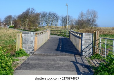 Prestatyn, UK: Mar 27, 2022: A Wooden Footbridge On The Outskirts Of Prestatyn Is Dedicated To Thomas Harland Who Lost His Life In A Road Accident Whilst Cycling In 2006