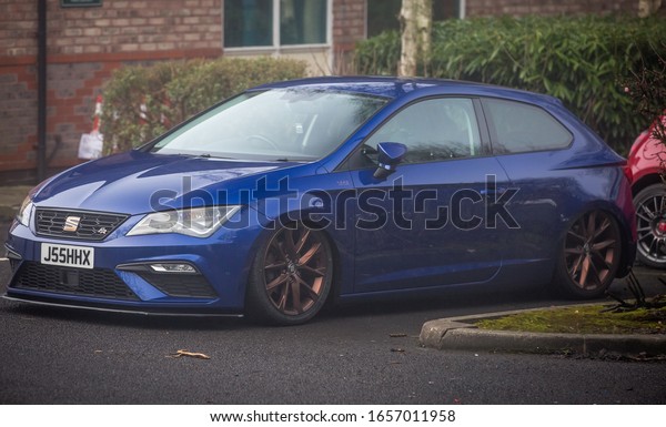 Preston, England, 19/01/2020 Seat Ibiza Leon Cupra\
FR hatchback car sat on air bags lowered slammed to the floor with\
aftermarket wheels attached in a foggy car park looking stanced\
J55HXX