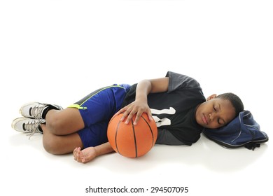 A Preteen Athlete Asleep With His Head On His Gym Bag And Hand Resting On His Basketball.  On A White Background With Space Over The Sleeper For Your Text.