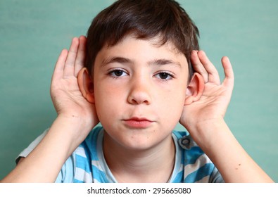 preteen beautiful boy hold his hear isolated on blue
