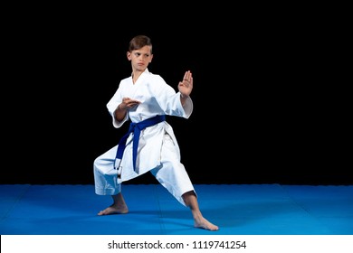 Pre-teen boy doing karate on a black background - Powered by Shutterstock