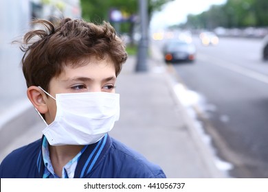 preteen boy in protection mask on the highway city background