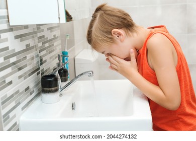 Preteen Boy Is Washed In A Wash Basin. Healthy Childhood And Lifestyle. Boy Washing Face In The Bathroom. Morning Hygiene. Dental Hygiene Every Day. Health Care, Childhood And Dental Hygiene.