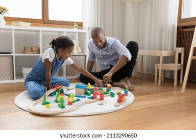 Pre-teen Daughter Spend Time With Loving Father, Play Together Wooden Cubes And Railroad, Enjoy Communication And Playtime On Carefree Weekend At Modern Playroom. Family Leisure, Fatherhood Concept