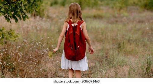 Preteen Girl With Backpack Walking In The Field In Summer Day Alone. Cute School Child Kid At Nature