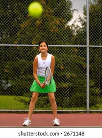 Preteen Girl Playing Tennis.