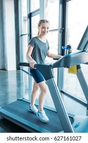 Preteen Girl Training On Treadmill In Fitness Class. Gym Class Kids Concept