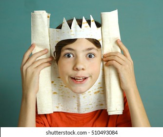 preteen handsome boy with rich imagination represent king with pita bread crown happy smiling close up photo on blue background