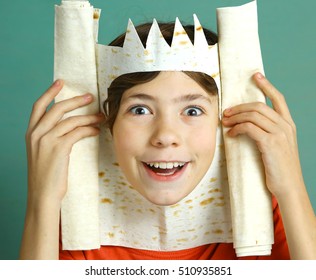 preteen handsome boy with rich imagination represent king with pita bread crown happy smiling close up photo on blue background