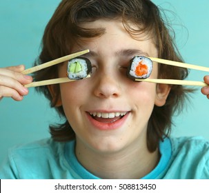 Preteen Handsome Boy With Sushi Roll Eyes And Sticks Close Up Smiling Photo