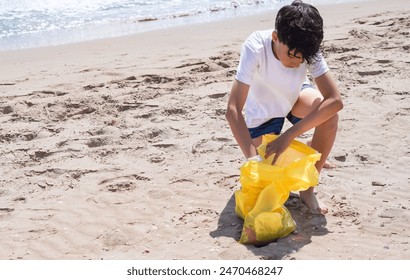 pre-teen picking up plastics on the beach - Powered by Shutterstock