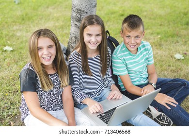 pre-teen School Pupils Outside of the Classroom with laptop