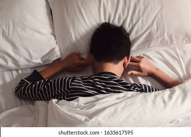 Preteen Tween Boy Covering Ears With His Fingers In Bed, ADHD, Sleep Disorder, Mental Health In Children, Not Want To Hear, Wake Up Kid For School, Teen Autism Down Syndrome Awareness Concept