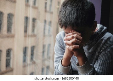 preteen tween boy hands closed praying alone, child religion, Christianity faith concept, Hope, World Day of Prayer,international day of prayer, social distancing, online worship at home