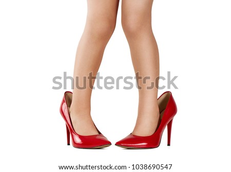 Pretending to be an adult. Close up of baby girl legs wearing oversized high heel shoes with copy space 