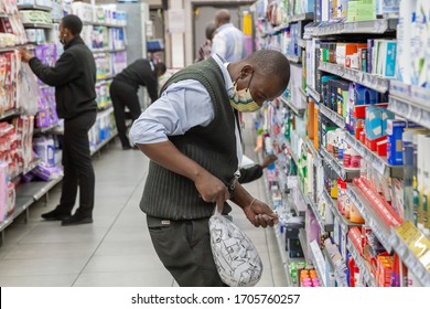 Pretoria, Gauteng South Africa 04 16 2020 Employee With Mask Marking Shelves With Prices In Grocery Store During Corona Virus Pandemic With Grain And Out Of Focus