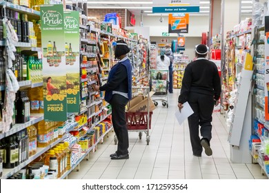 Pretoria, Gauteng, South Africa, April 24 2020, Staff Stocking Shelves During Corona Virus Pandemic With Facial Mask In Supermarket Out Of Focus With Grain