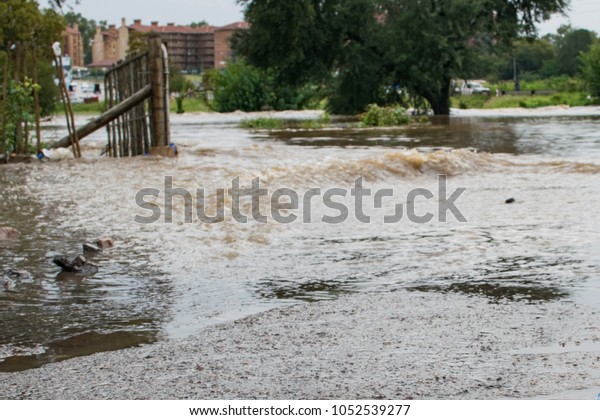 Pretoria, Gauteng, South\
Africa - March 23 2017: Flooding results in river bursting banks,\
flooding hotel. 