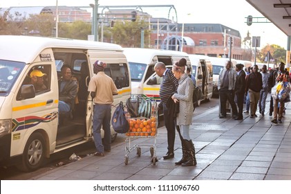 Pretoria, South Africa, June 7 - 2018: Commuters At Minibus Taxi Rank Looking At Oranges On Sale.