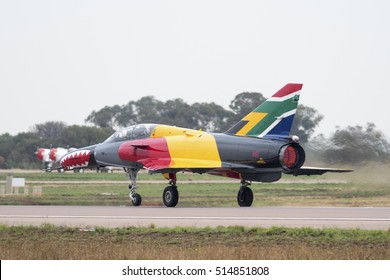 PRETORIA, SOUTH AFRICA-SEPTEMBER 17 2016: Flames From The Tail Pipe Of A Brightly Coloured Ex-SAAF Cheetah Jet Taking Off At  The African Air Defense Show At AFB Waterkloof