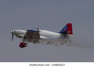 PRETORIA, SOUTH AFRICA-SEPTEMBER 17 2016: A Nashua Sponsored Zlin Aerobatic Aircraft Flies Past With Smoke At The African Air Defense Show At AFB Waterkloof