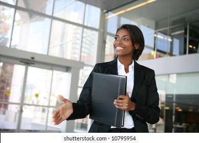 A Pretty African American Business Woman Offering A Handshake