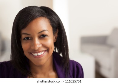 Pretty African American Business Woman Wearing Purple Jacket And Black Shirt.