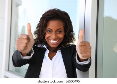 A pretty african american business woman with thumbs up