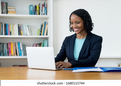 Pretty African American Businesswoman Working At Computer At Homeoffice To Stay At Home