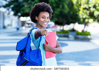 Pretty African American Female Student In City Walking To University In Summer