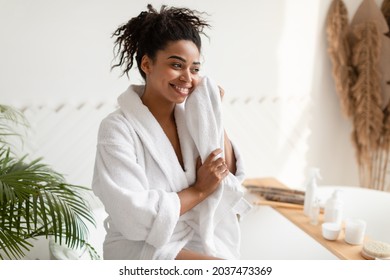 Pretty African American Lady Drying Face With Soft Towel Looking Aside, Caring For Skin In Bathroom Indoor. Facial Skincare And Pampering, Beauty Routine Concept - Powered by Shutterstock