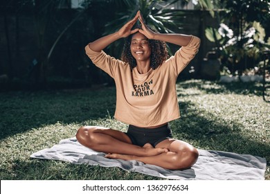 Pretty African American Woman Sitting On Green Grass Doing Yoga. T-shirt With Sign 