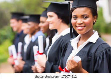 Pretty African Female College Graduate At Graduation With Classmates