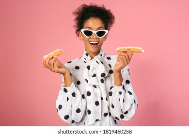 Pretty  African  Female With Suprice Face   Holding Sweets And Posing Over Pink Background. 