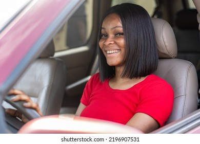 Pretty African Lady Driving Her Car Smiling