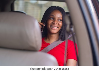 Pretty African Lady Making A Phone Call In A Car