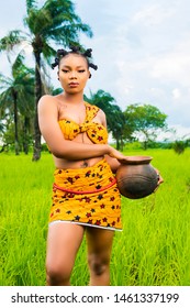 pretty african tribe girl carrying a clay pot