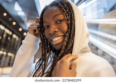 pretty african woman with dreadlocks and hood in the city happy smiling looking at camera young african american girl. - Shutterstock ID 2278483299