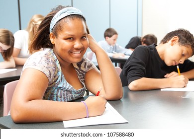 Pretty African-American girl in diverse middle school class.