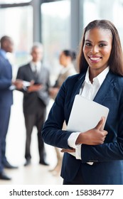 pretty afro american businesswoman holding laptop in office
